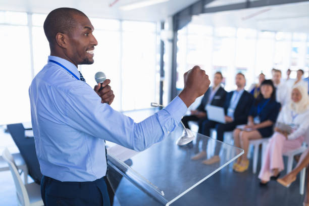 Side view of caucasian Male speaker speaks in business seminar at conference meeting. International diverse corporate business partnership concept